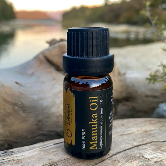 bottle of blackfern botanical manuka oil 10ml in fornt of blurry scenic backdrop